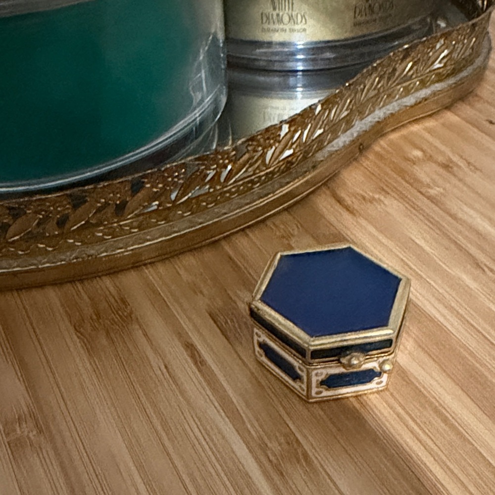 Estee Lauder hexagonal solid perfume compact, likely from the 1970s or 1980s.